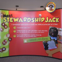 Curved pop-up display with stand-off graphics and mural designed by Vision Exhibits
